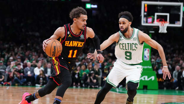Atlanta Hawks guard Trae Young dribbles past Boston Celtics guard Derrick White.